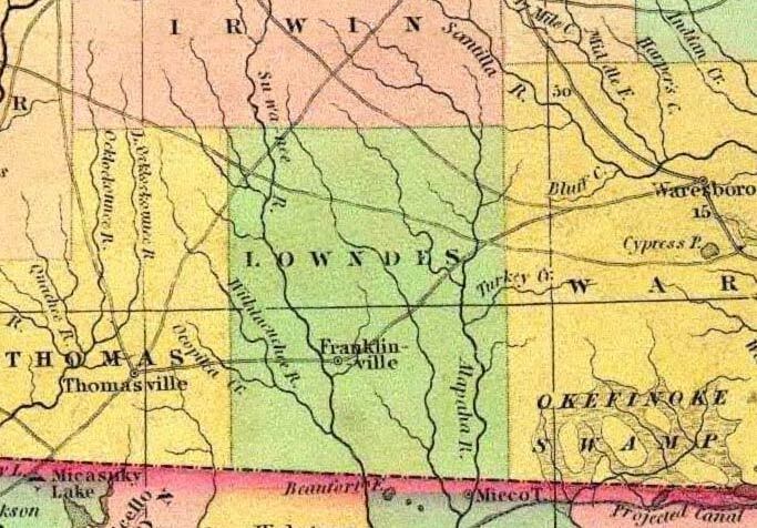 Lowndes County, 1834, GeorgiaInfo, with something marked as “Ocopilca Cr.” that joins the Little River, which is marked as “Withlacuchee R.”, and Franklinville on the Withlacoochee River marked as “Su-wa-nee R.” and “Beaufort F.” shown just south of the state line. Apparently Franklinville Road from Thomasville through Franklinville to “Waresboro” in Ware County was the oldest road through Lowndes County after Coffee Road. Also apparently Hutchinson’s Mill Creek and Cat Creek ran into Grand Bay Creek back then, on to the Alapahoochee and the Alapaha. The “Okifinoke Swamp” was considered to extend way west, almost to the Alapaha. “Micco T.” is shown in Hamilton County, Florida, with a “Projected Canal” come south of the swamp towards it.