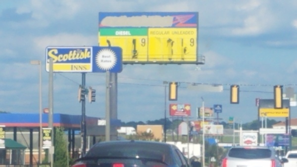 [Gas station sign, 16:27:57, 31.4455556, -83.5422222]