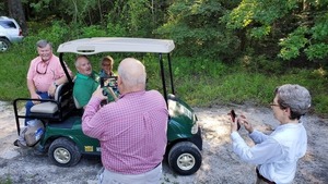 [Don and Helen photographing golf cart VIPs, 08:44:11, 30.84721, -83.34752]