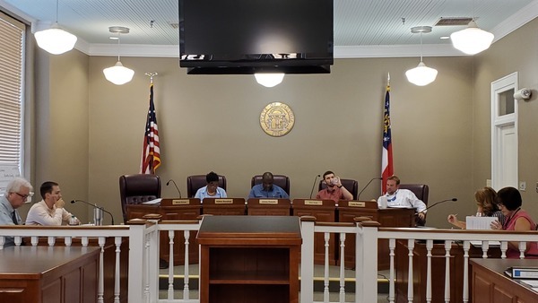 [Attorney?, County Administrator Hampton Raulerson, Absent Jesse Crews (3), Vice Chair Alphya Benefield (1), Chair James E. Everett (2), , Drew Jones (4), Luke Gowen (5), County Clerk Jenifer Nobles, Finance Coordinator Rebecca Harden]