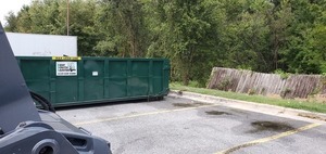 [Dumpster and broken fence]