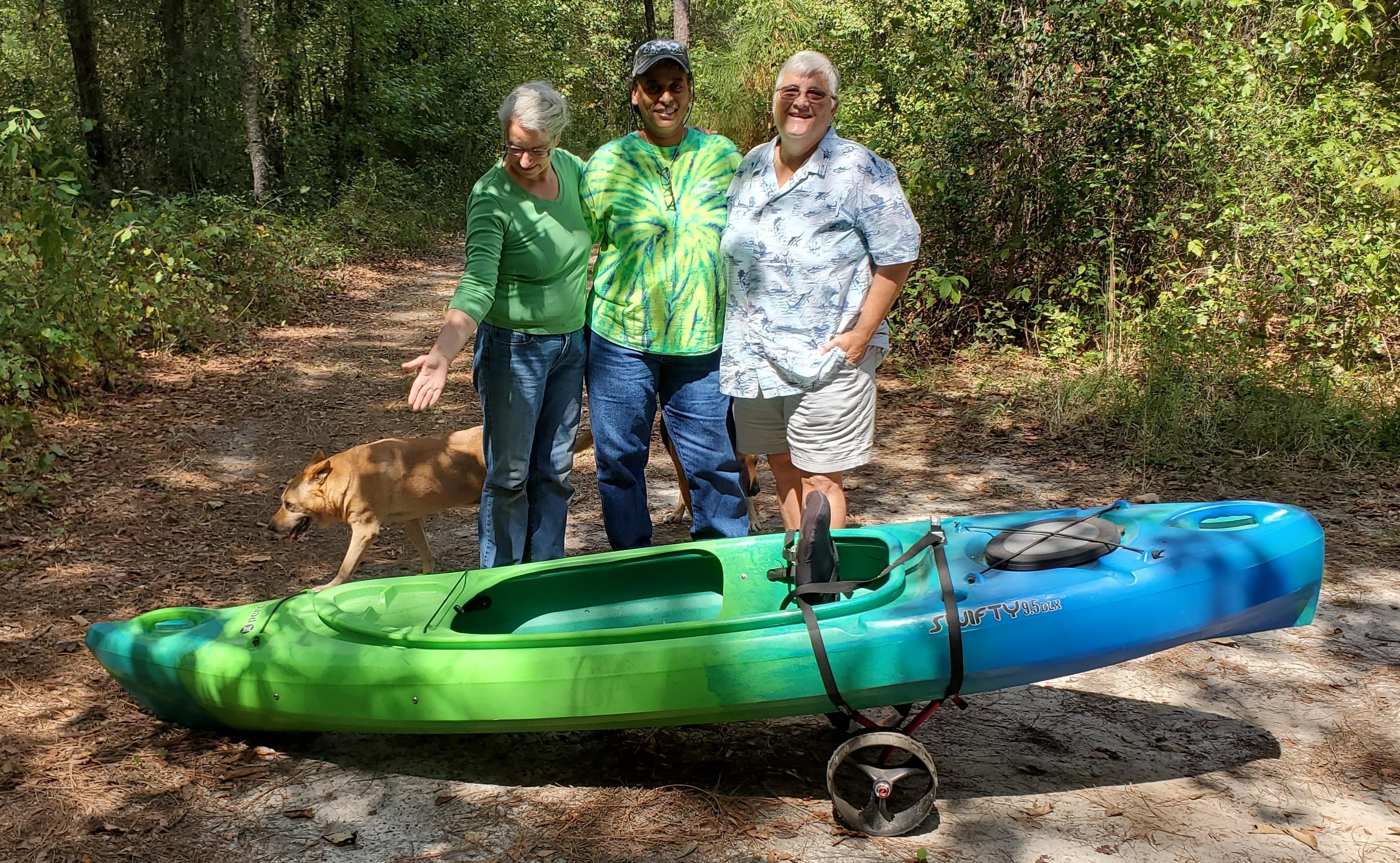 Raffle kayak with Gretchen, Cindy, Amy, and Yellow and Brown Dog