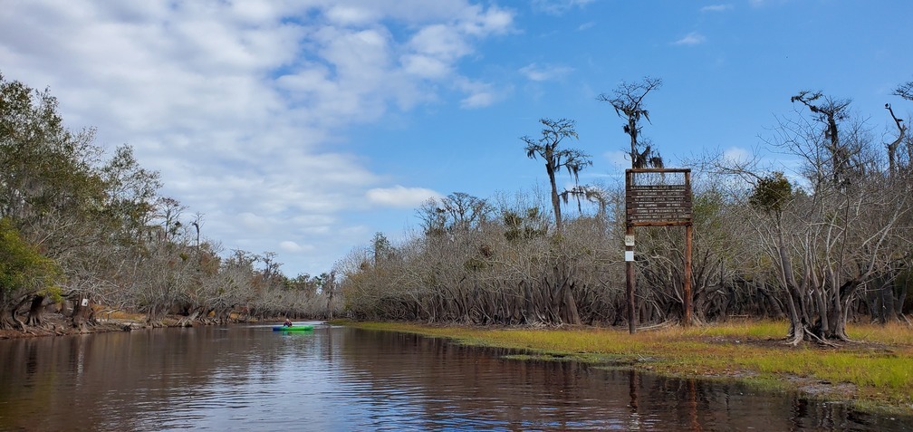 Distant Okefenokee NWR sign, 11:33:36, 30.7943272, -82.4359553