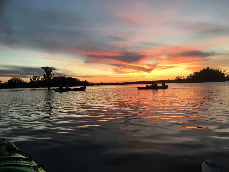 Sunset behind paddlers