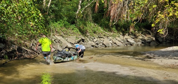 [Bobby McKenzie and Scotti Jay hauling tire boat over sandbard]