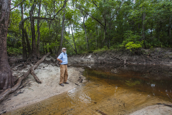 [John Quarterman stands by the Withlacoochee River in Georgia. Matt Odom / for NBC News]