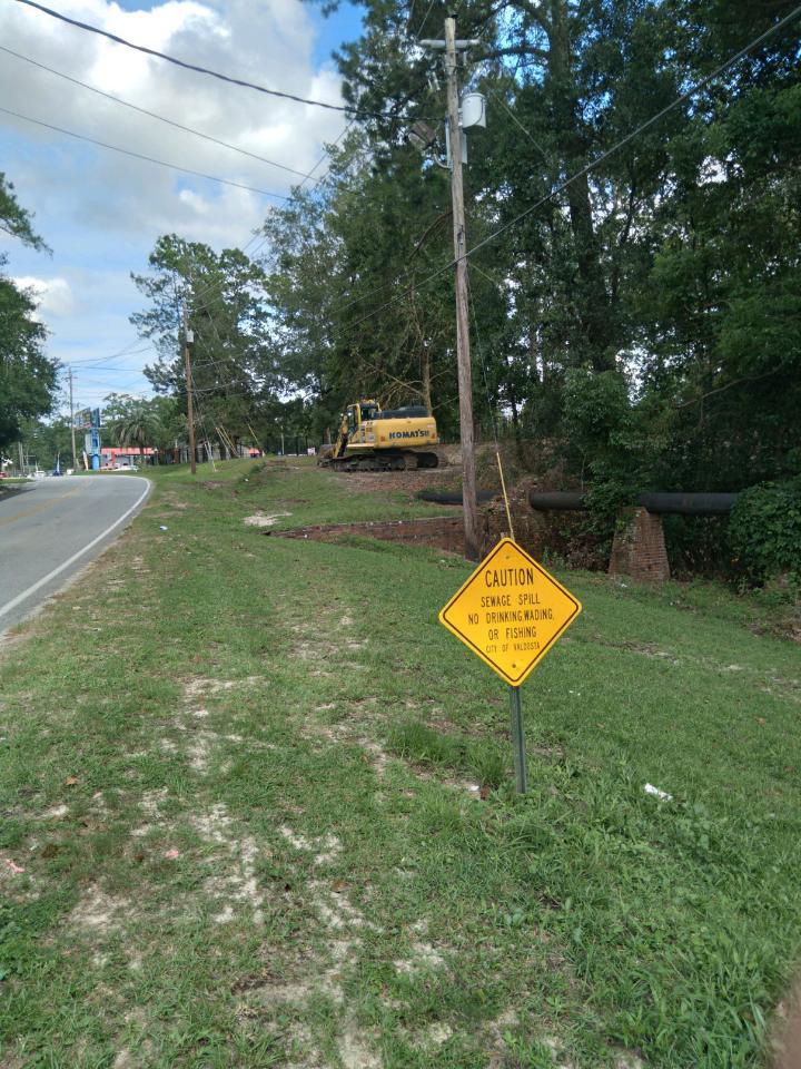 Warning sign, above-ground sewer pipe, equipment