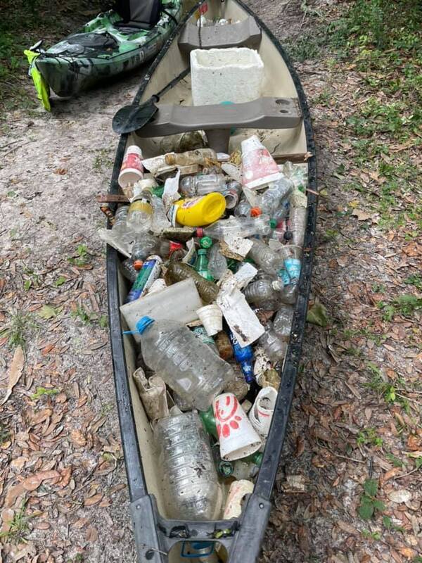 Canoe with trash by Bobby McKenzie