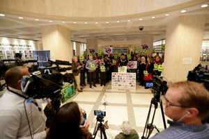 [Suwannee Riverkeeper banner at NRTR press conference, FL Capitol Rotunda --Alicia Devine/Tallhassee Democrat, 2021-03-03]