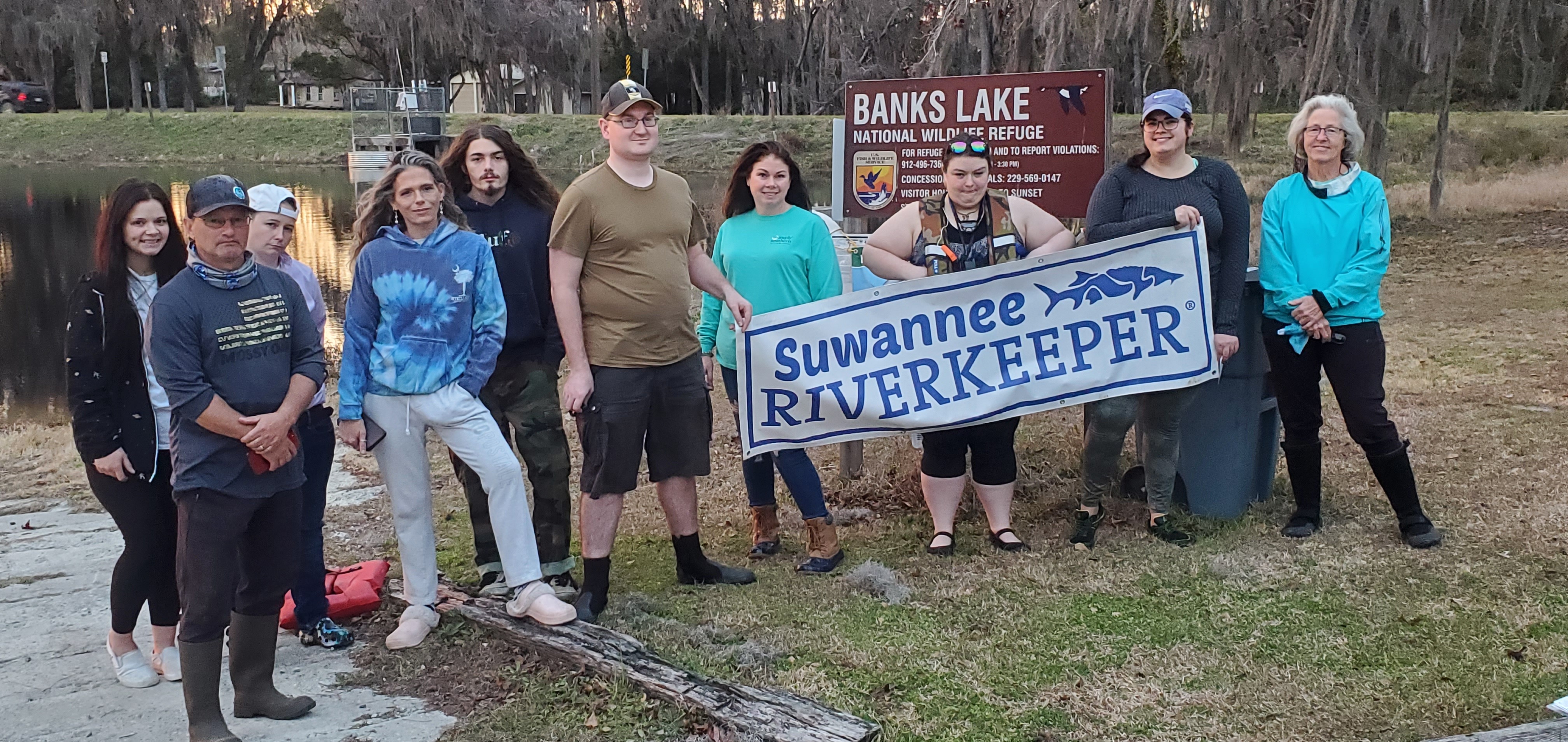 Ten intrepid paddlers with banners