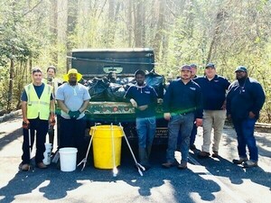 [Stormwater litter crew with bags of trash]