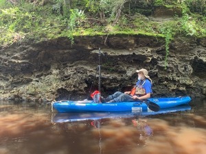 [Suwannee Riverkeeper under a limestone balcony --Shirley Kokidko]