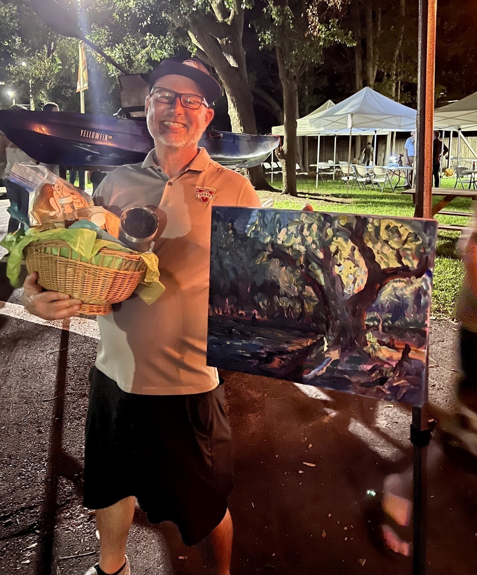 Raffle Kayak won by Mala Vallotton; Steve Miller with Okra Paradise Farms food and Julie Bowland painting