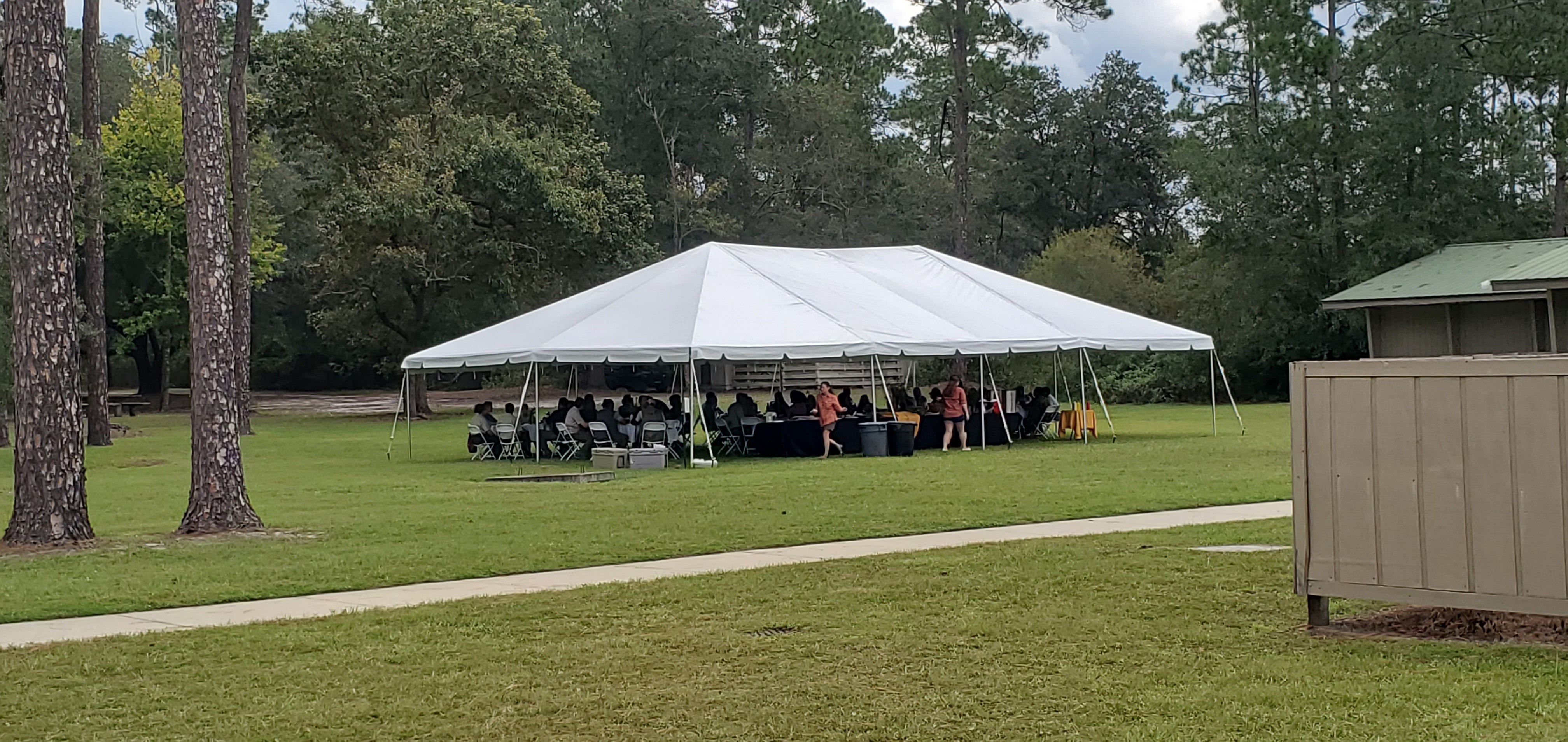 context: Dignitaries lunching in a tent, 12:23:21, 30.7385786, -82.1401877