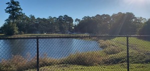 [Fence and detention pond, 2022:10:18 09:11:40, 30.8469103, -83.2793843]