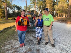 [Holly Jones and family with the boat she won --Gretchen Quarterman]