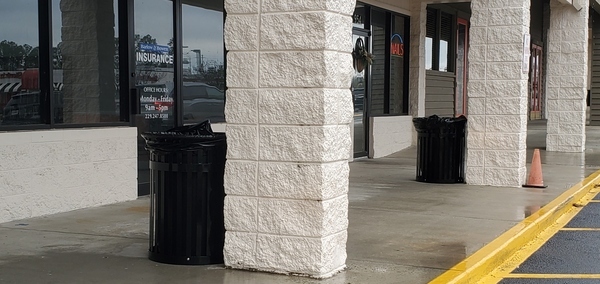 [Trash cans by storefronts]