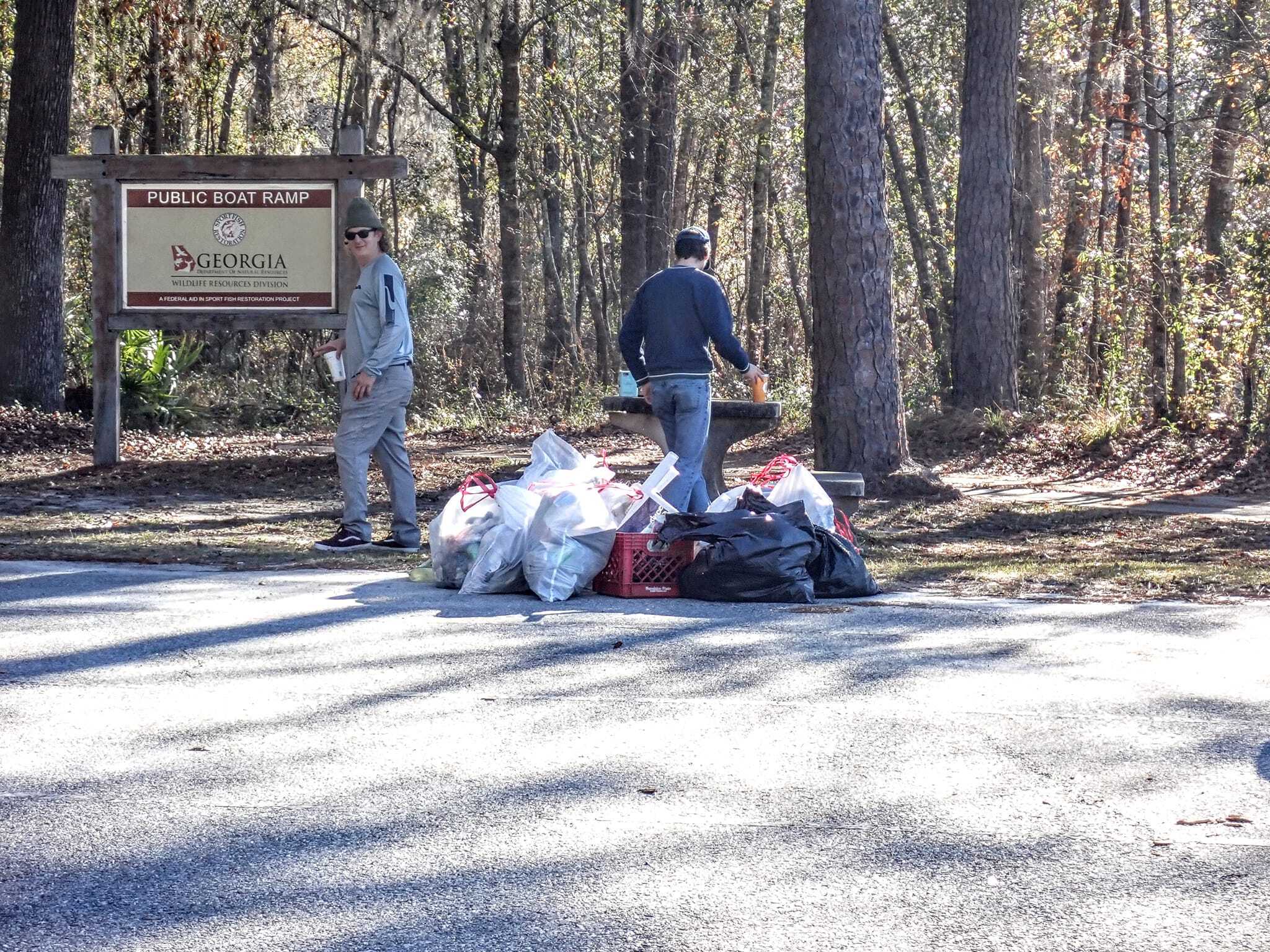 Bird Chamberlain and David Rodock with trash bags at Statenville --Suzy Hall