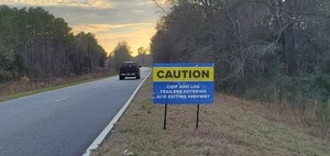 [Caution: chip and log trailers entering and exiting highway, 17:22:16, 30.9595396, -83.4556233]