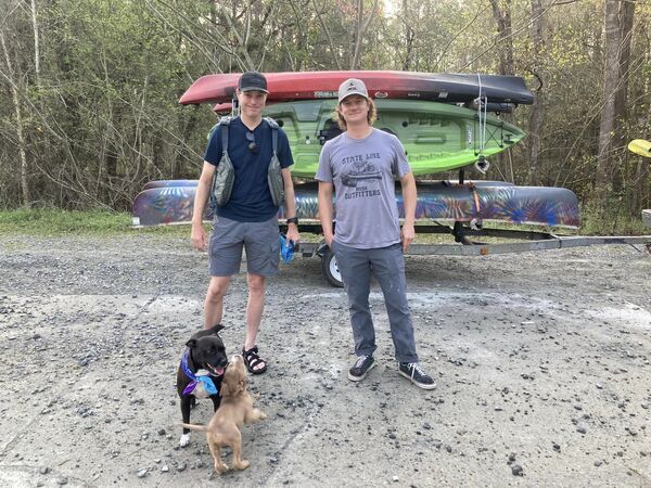 [Bird Chamberlain with State Line Outfitters boats, his dog, and the lost puppy]