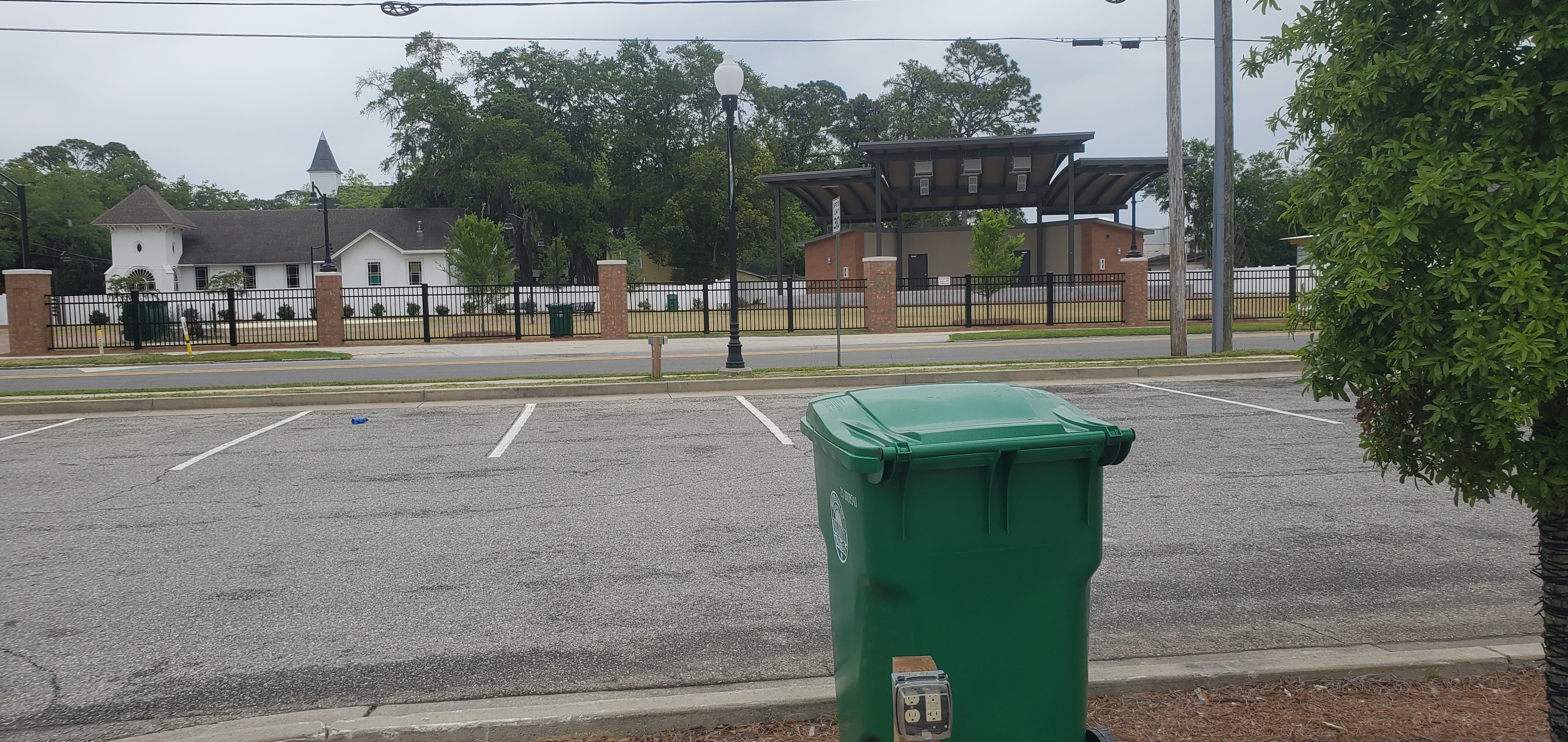 Unity Park amphitheater and trash cans in parking lot