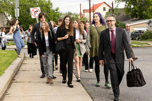 [Plaintiffs in the case walk on Monday morning to the Lewis and Clark County Courthouse In Helena, Mont., joined by Mat dos Santos, a lawyer for Our Children’s Trust, right.Credit...Janie Osborne for The New York Times]