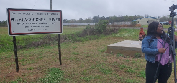 [Entrance sign with WTXL reporter Malia Thomas]