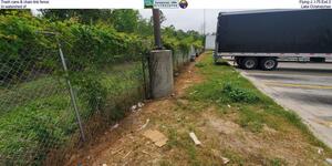 [Trash cans & chain link fence, Flying J, I-75 Exit 2, In watershed of Lake Octahatchee]