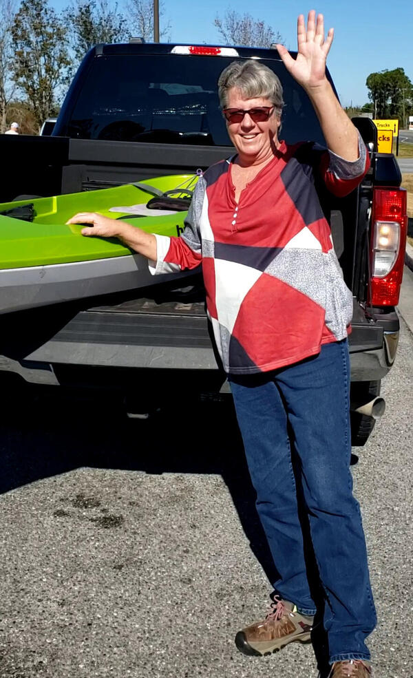 [Belinda Edwards Herndon with the Skimmer 128 Hurricane kayak she won 2024-12-19]