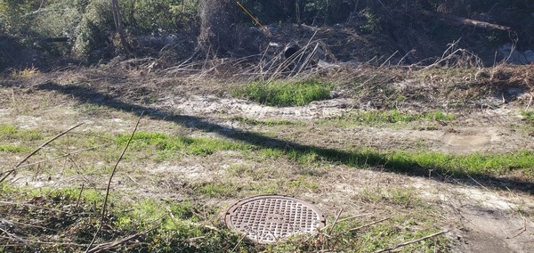 Closeup, manhole, Westbrook Circle sewer line, Sugar Creek, 2025:01:02 13:10:46, 30.8505952, -83.3143212