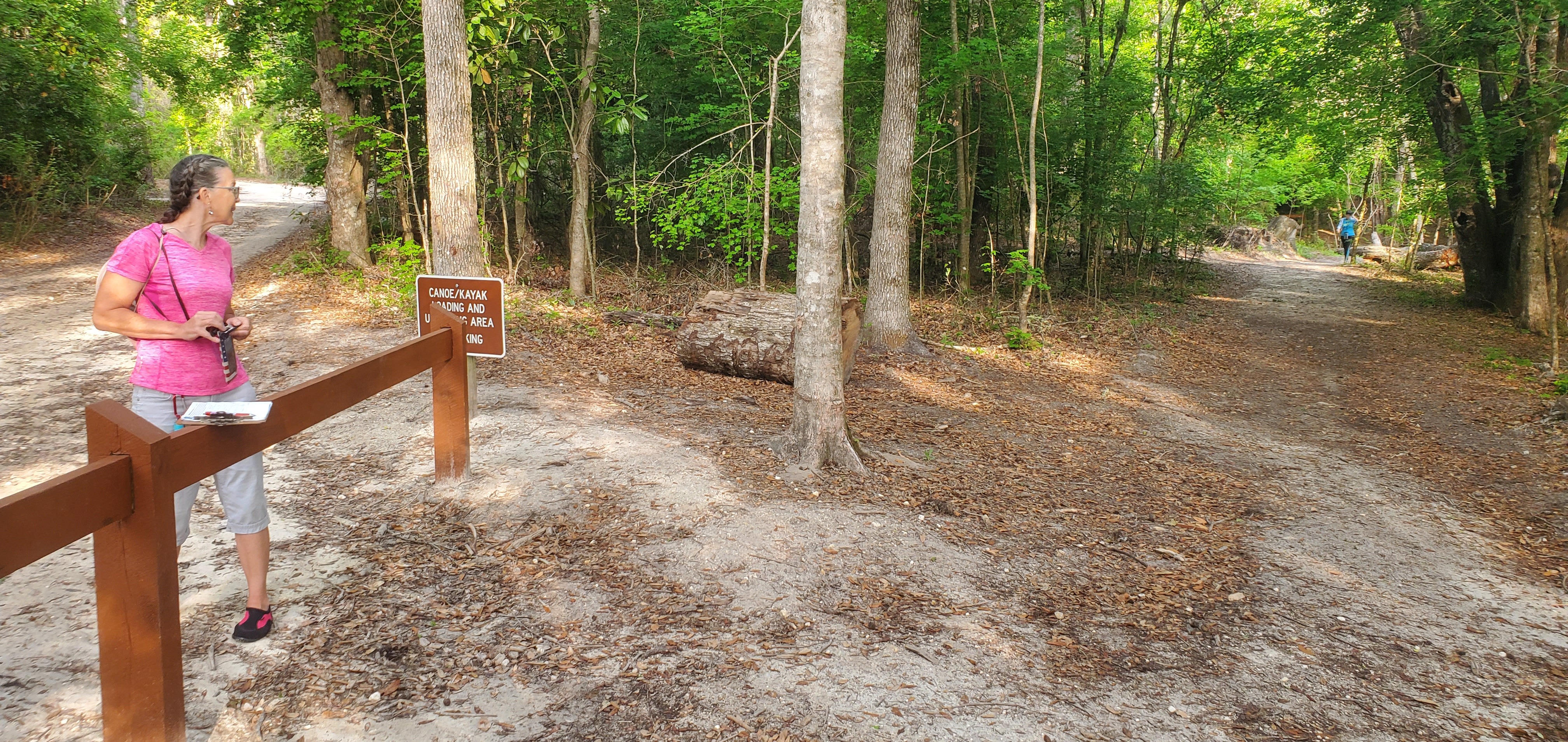 Tish Hall with sign-in sheet, Kim Tanner coming out of the woods, 08:36:20, 29.9831145, -82.7609911