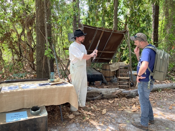 [Chris Turtleman Adams demonstrating an old rifle at his still --Gretchen Quarterman]