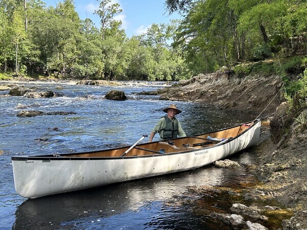 [Dennis Price walking his canoe around Big Shoals --Shirley Kokidko]