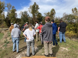 [Students on the AAWTP dam, 2025:11:21 11:27:23, 31.3886694, -83.2182222 --Gretchen Quarterman for WWALS]