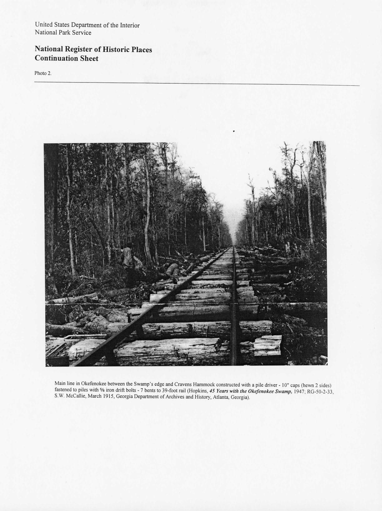 Photo 2: Main line in Okefenokee between the Swamp’s edge and Cravens Hammock constructed with a pile driver - 10inch caps (hewn 2 sides) fastened to piles with % iron drift bolts - 7 bents to 39-foot rail (Hopkins, 45 Years with the Okefenokee Swamp, 1947, RG-50-2-33, S.W. McCallie, March 1915, Georgia Department of Archives and History, Atlanta, Georgia)