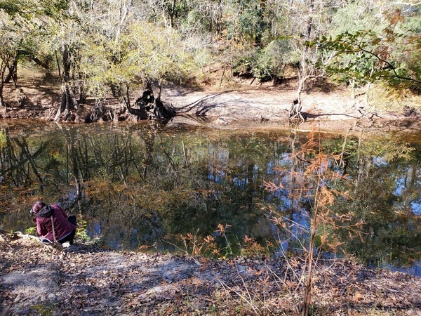 Reporter on riverbank