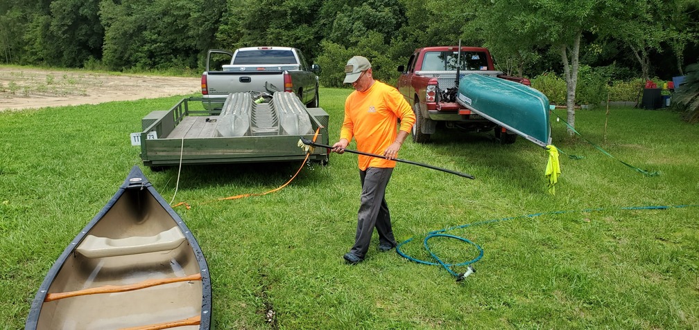 Russell washing the canoes, 14:57:51, 30.8365549, -83.5225833