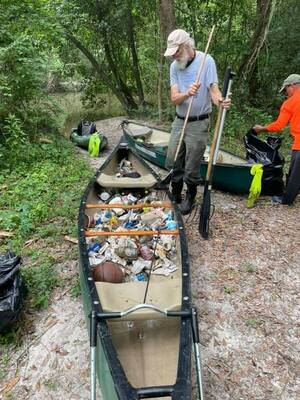 [Two canoes with trash by Bobby McKenzie]