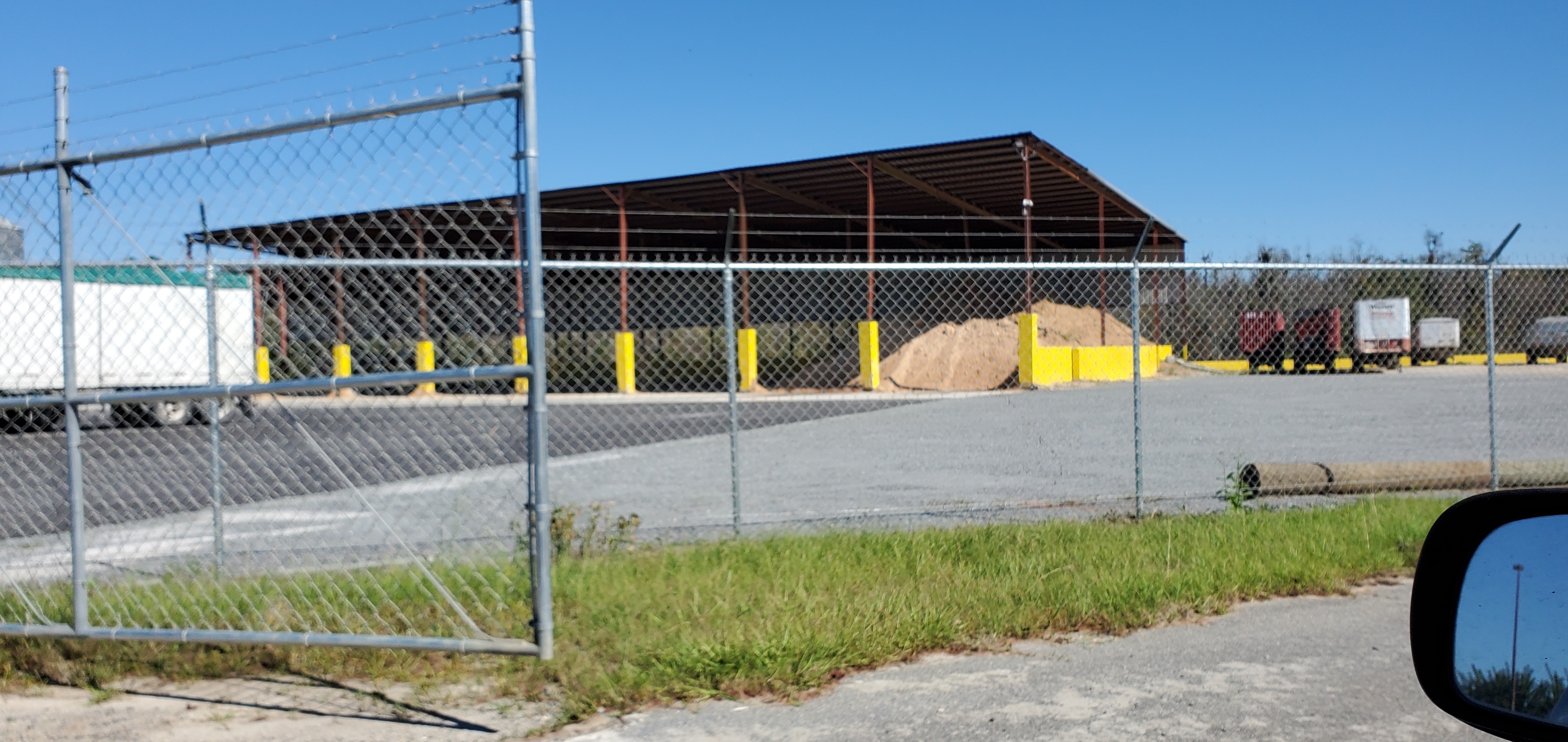 Metal roof with sand piled under it, 14:00:24, 31.0657880, -83.1968710