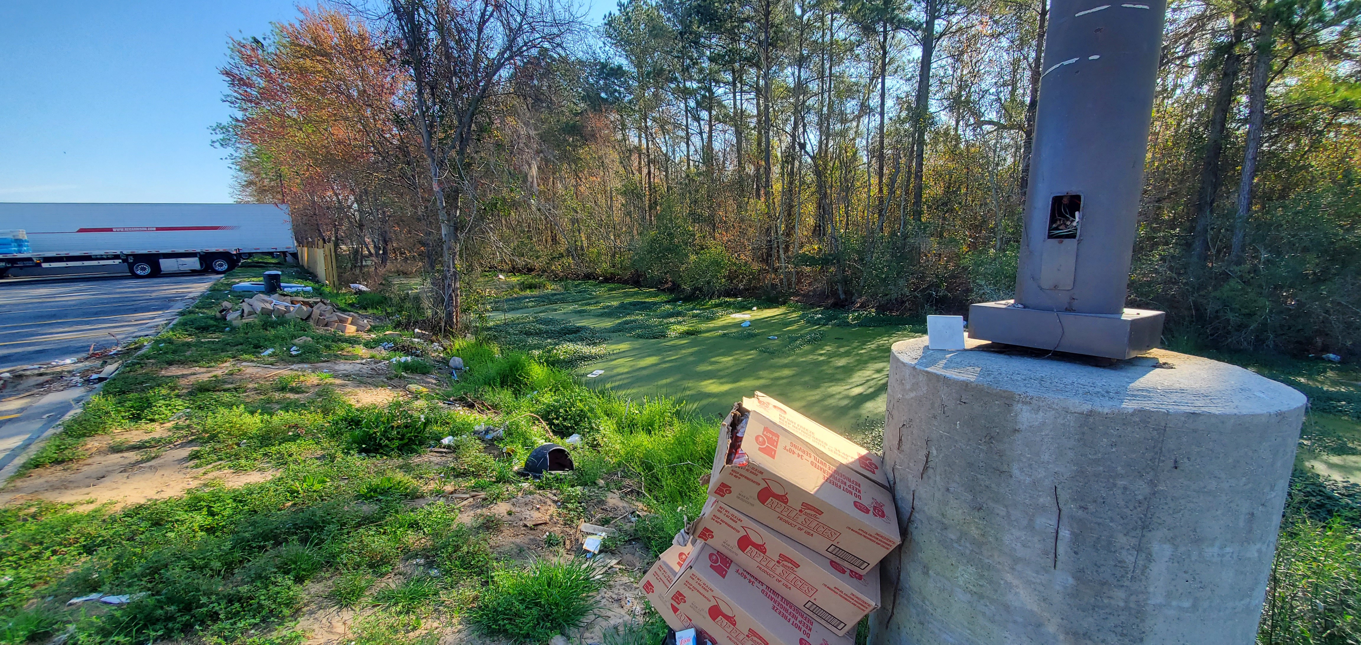 Piled boxes to trash in water, 09:28:56, 30.6405719, -83.1890052