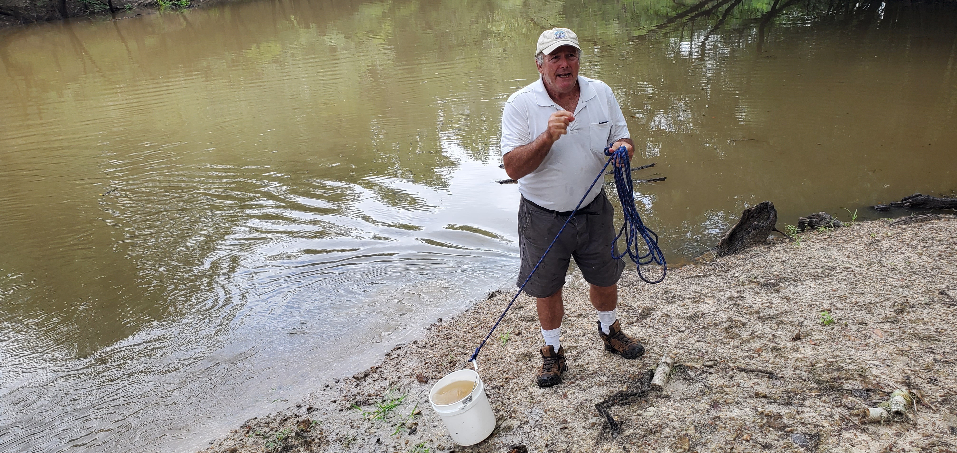 Michael Bachrach with sample in bucket, 10:52:26, 30.7124383, -83.4555408