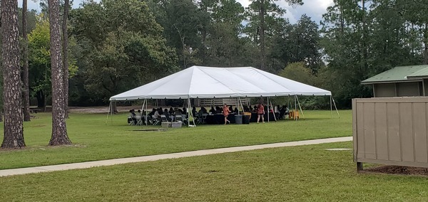 context: Dignitaries lunching in a tent, 12:23:21, 30.7385786, -82.1401877