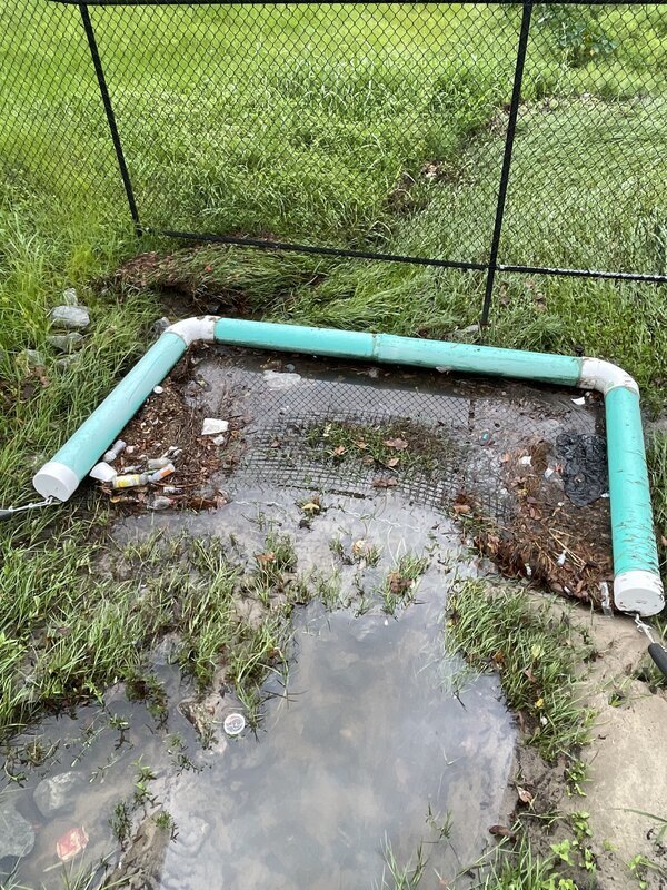 Trash was pushed into the pond by the afternoon rain event on 10 September 2022