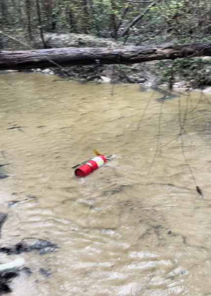 Fire extinguisher in creek; Photo: Bobby McKenzie