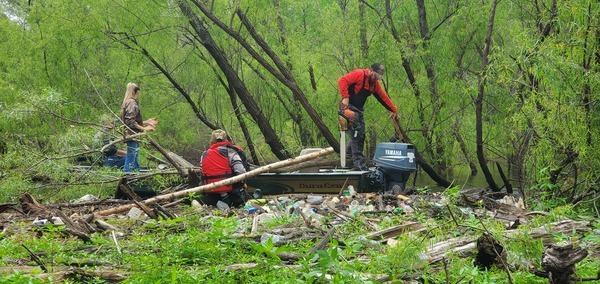 Russell putting trash in the power boat, 11:56:03, 30.6903420, -83.4406915