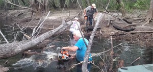 [Movie: Phil Hubbard cuts a limb from Portage Logjam, 30.7156360, -82.5186400 (24M)]