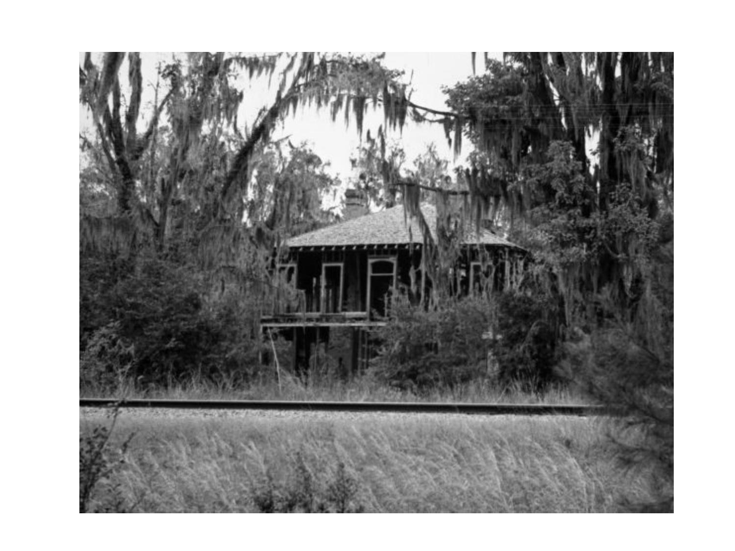 Photo: Old house beyond railroad