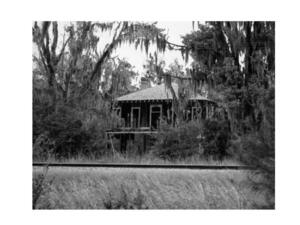 [Photo: Old house beyond railroad]