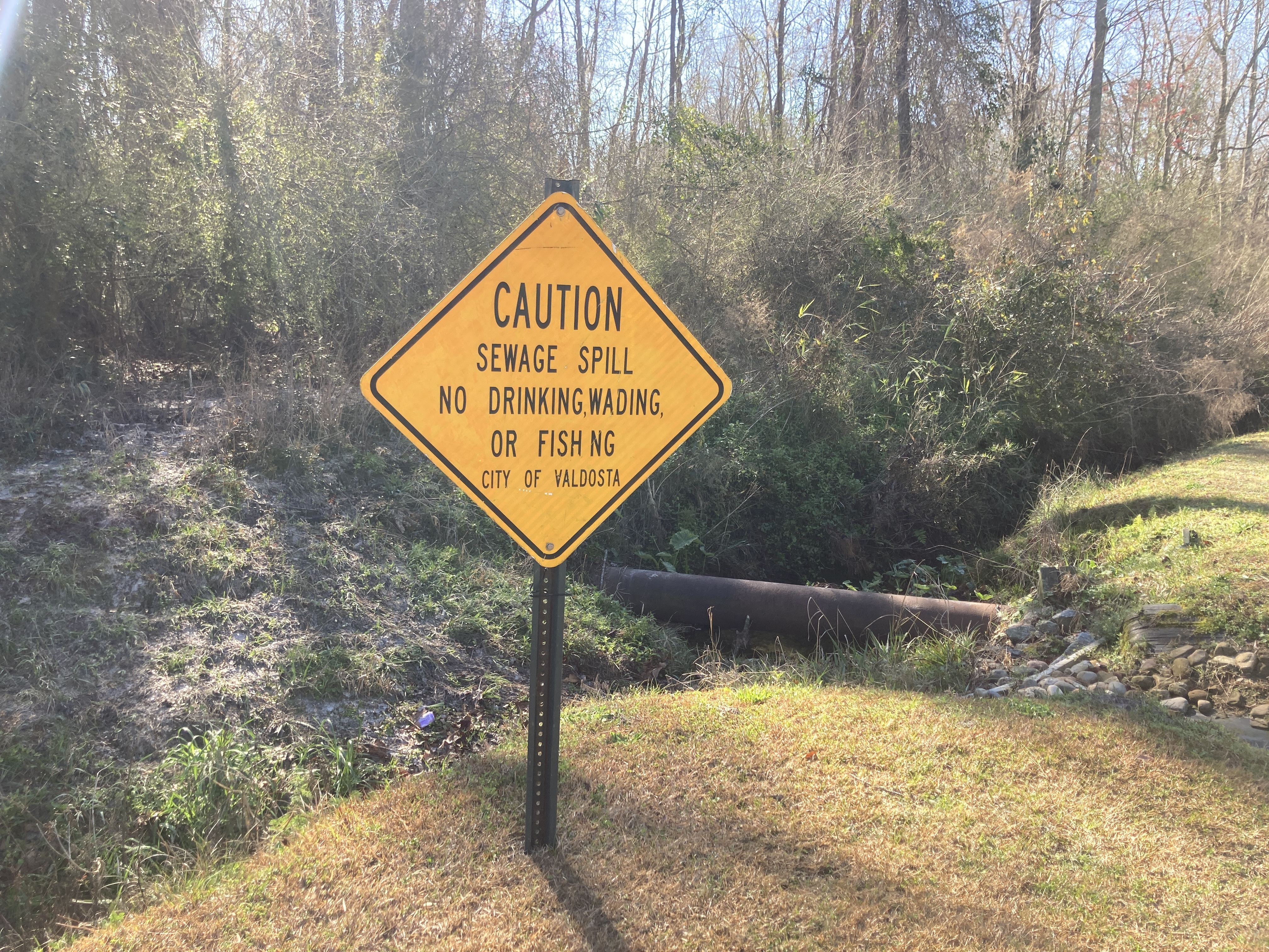 Manhole, sign, and sewer pipe