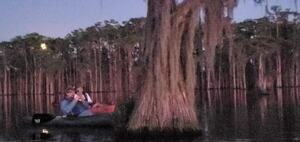 [Movie: Bats flying in front of the rising moon with expedition leader Shirley Kokidko (75M)]